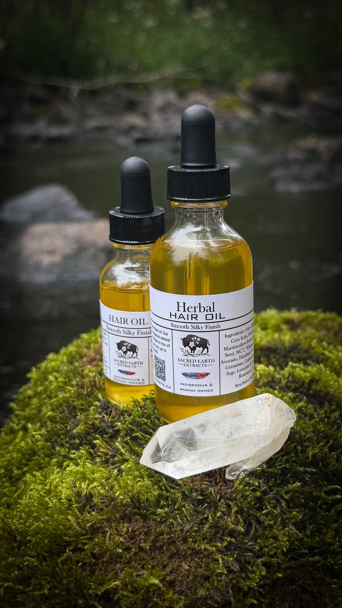 Two bottles of Herbal Hair Oil from an angle