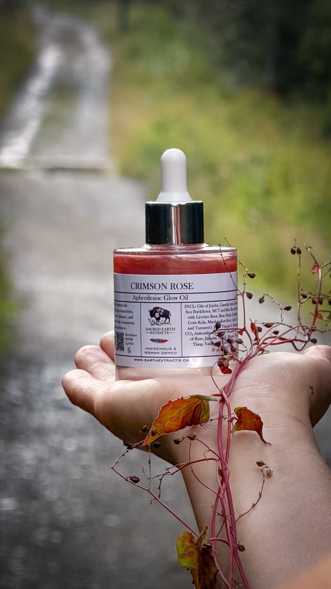 Crimson Rose aphrodisiac glow oil held in open hands