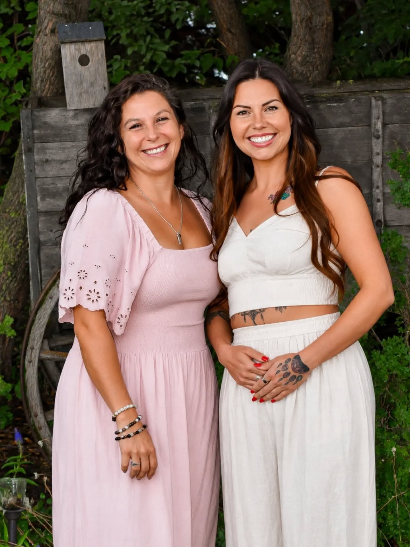 Karren and Jenny, co-owners of Sacred Earth Extracts, standing together in a garden